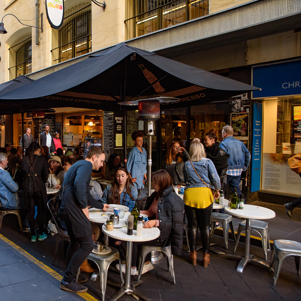 People sitting at outdoor cafe seating | SV Partners
