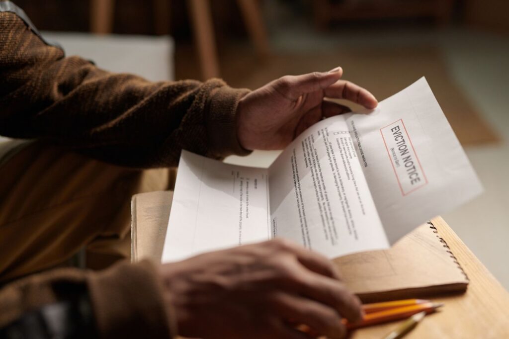 Person opening and reviewing a formal legal notice document