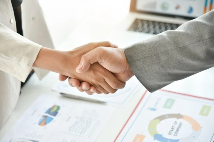 Two people shaking hands for a notice of winding up
