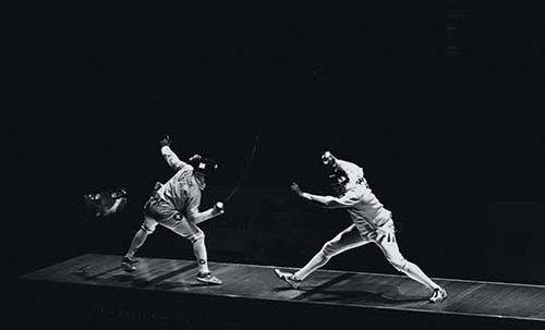 Two athletes competing in a fencing match | SV Partners