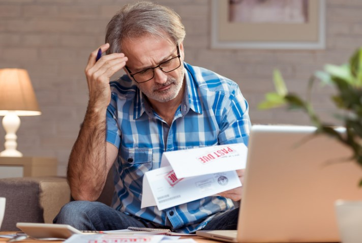 Man reading bankruptcy letter